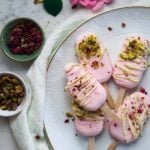 rose milk popsicles with white chocolate cardamom and pistachios