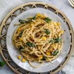 spicy lemon spaghetti in a plate with basil and corn