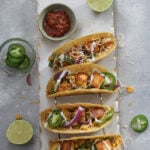Taco board with paneer, jalapenos, bell peppers and spice lime crema.