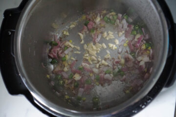 Tadka for spinach dal. Oil with cumin seeds, hing, onions, green chilies, ginger and garlic