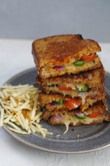Inside out grilled cheese Stacked grilled cheese with jalapenos, onions and tomatoes