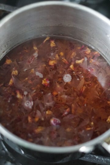 rose petal simple syrup in a pot
