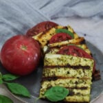 grilled garlic basil paneer on a plate with tomato