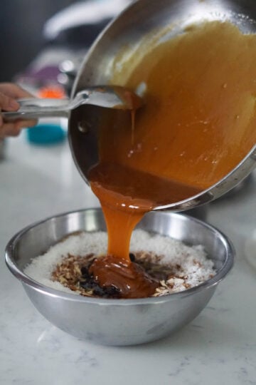 Melted jaggery and ghee poured into churma ladoo