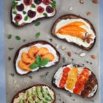 Five Breakfast Toasts on parchment with fruit and garnish