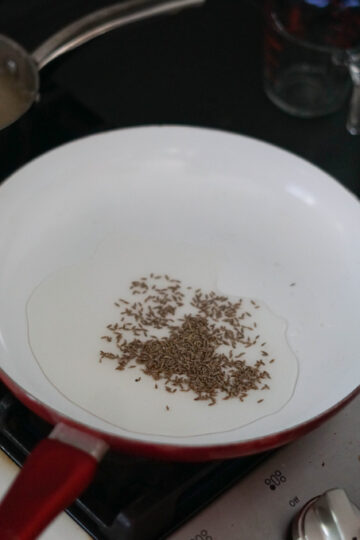 Heated oil in a pan for cauliflower subzi shaak