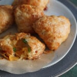 baked samosas with puff pastry on a white plate.