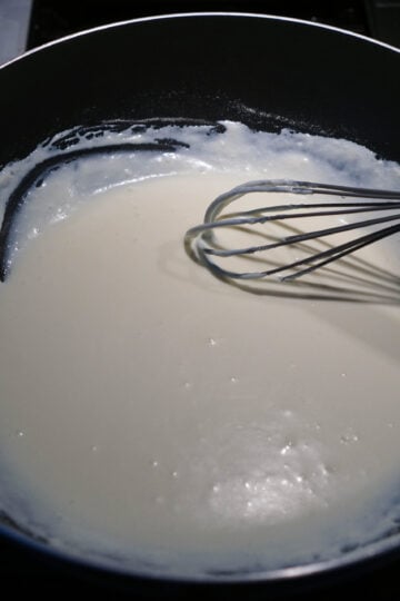 Cookies and cream burfi indian fusion dessert ingredients in a bowl whisked.