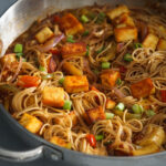 chilli paneer noodles in a wok