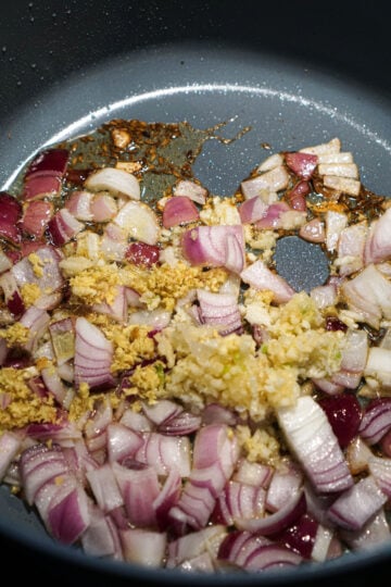 Onions, garlic and ginger added to the pan.