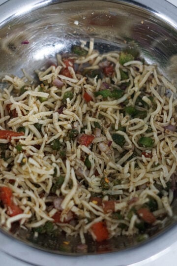 cheese, spices, vegetables mixed in a bowl
