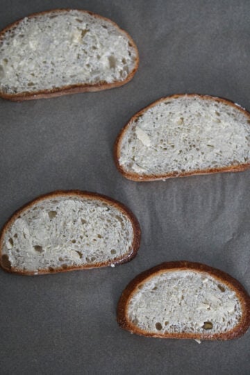 buttered bread on a baking sheet