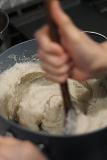 stirring khichu with a velan.