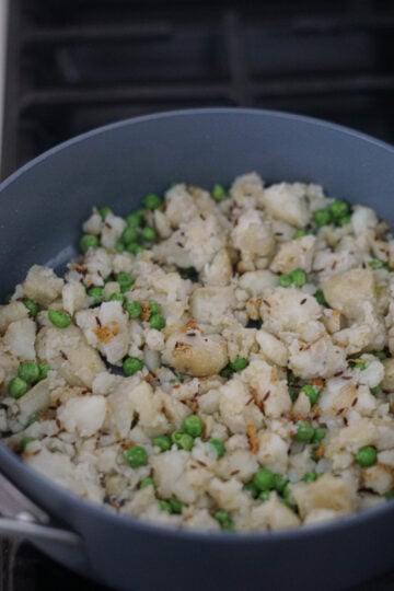 peas and potatoes in skillet