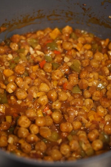 crispy chana chick peas into spicy veg sauce
