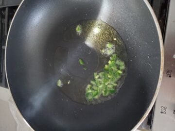 Heated oil in a pan with jalapenos