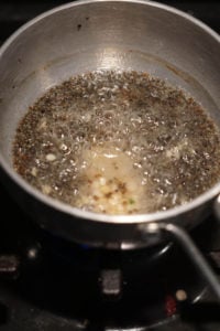 Tadka in small pot on stove