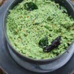 Coconut chutney in a gray bowl on a gray plate