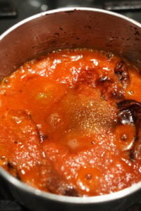 Momo chutney ingredients in a small pot cooking.