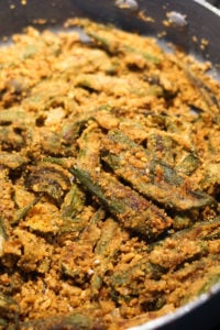 Leftover besan flour added to okras in pan and cooked.