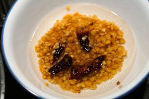 Soaking urad and chana dal with red chillies in water