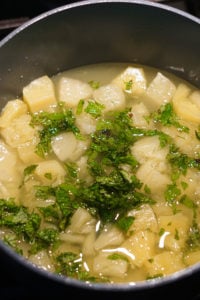 Pineapple and mint in a pot cooking.