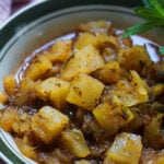 Pinapple chutney in a bowl with mint as garnish.