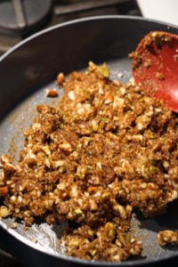 Mixed date nut roll ingredients in a non-stick pot.