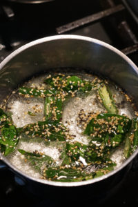 Water and khaman tadka in a pot with sugar boiling.