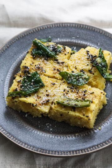 Khaman with tadka poured on top and dessicated coconut.