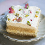 Ras Malai Cake slice on a fluted white plate