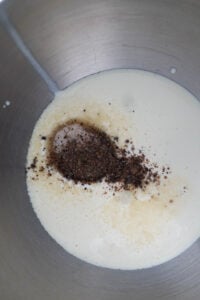 Cardamom rose whipped cream ingredients in a steel bowl.