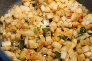 Cooked potatoes in a pan with spices.