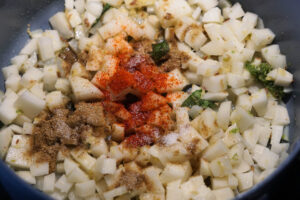 Potatoes added to pan with spices.