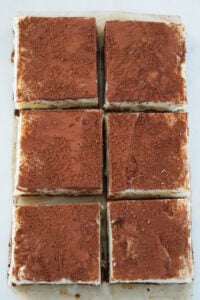 Tiramisu burfi cut into six square pieces.