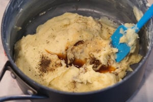 Vanilla extract and cardamom added to barfi mixture.