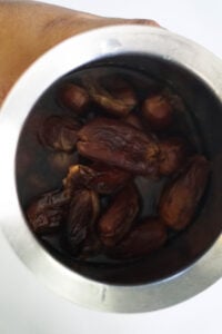 Soaked dates in water in a bowl.