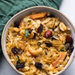 Poha chevdo in a bowl with peanuts, cashews and raisins.