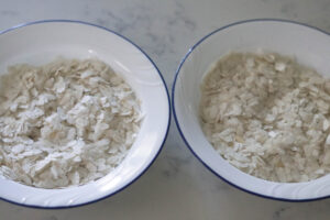 Roasted poha in a microwave in two plates.