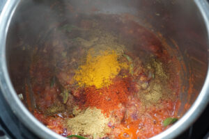 Crushed tomatoes and spices added to Instant Pot.