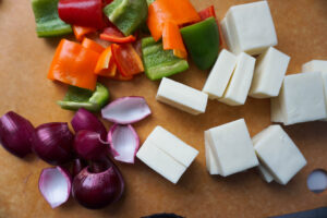 Red onions, bell peppers (capsicum) and paneer cut into cubes.