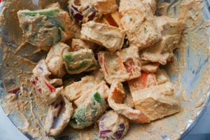 Paneer, bell peppers and onions tossed in the marinade.