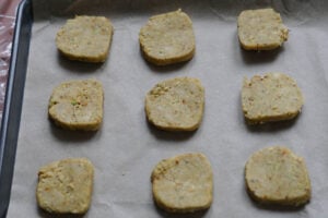 Cookies laid on parchment lined baking sheet to be baked.