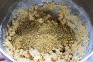 Ground pistaschios added to mixing bowl.