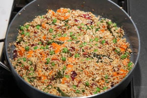 Rinsed quinoa added to pan.
