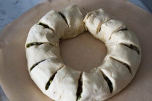 Samosa rolled in puff pastry, seam side down with cuts made every two inches.