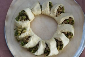 Samosa wreath pieces turned out and laid on a parchment lined pan to bake.