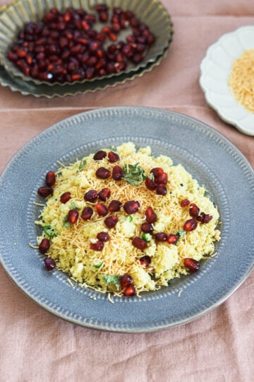 Sev khamani on a plate with pomgrantes, cilantro and sev.