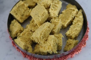 Vati dal khaman cut into square pieces.