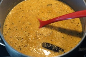 Roasted chana dal chutney cooking in pot.